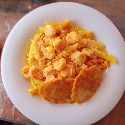 a plate of food with pasta on a table at Tintipán Glamping in Tintipan Island
