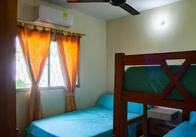 a bedroom with two bunk beds and a window at Alojamiento Familiar #2 - La mejor playa y mar in Puerto Viejo