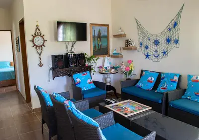 a living room with a couch and a table at Alojamiento Familiar #2 - La mejor playa y mar in Puerto Viejo
