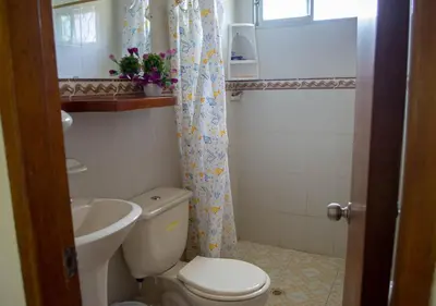 a small bathroom with a toilet and a sink at Alojamiento Familiar #2 - La mejor playa y mar in Puerto Viejo