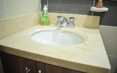 a bathroom sink with a marble counter top at Luxury apartment with pool in Barranquilla