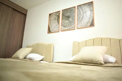 a bedroom with a bed with two mirrors above it at Luxury apartment with pool in Barranquilla