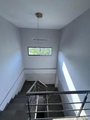 a staircase in a room with a window at Villa Matthew - Villa de Lujo con Piscina Privada y BBQ, Cerca al Mar in Juan de Acosta