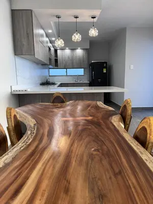 a dining room with a wooden table and a kitchen at Villa Matthew - Villa de Lujo con Piscina Privada y BBQ, Cerca al Mar in Juan de Acosta