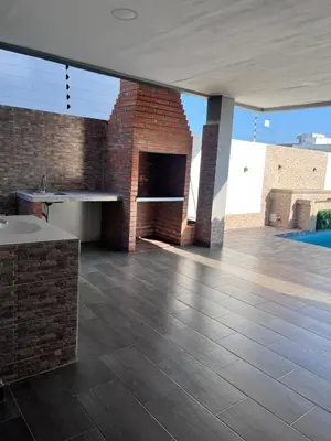 a living room with a brick fireplace in a house at Villa Matthew - Villa de Lujo con Piscina Privada y BBQ, Cerca al Mar in Juan de Acosta