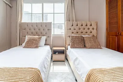 two beds sitting next to each other in a bedroom at Luxury House Perfect Location in Cartagena de Indias