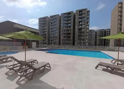 a swimming pool with lounge chairs and umbrellas at Luxury apartment - Barranquilla 10 minutes to Buenavista in Barranquilla