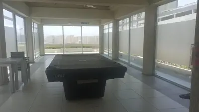 a room with a pool table in front of windows at Luxury apartment - Barranquilla 10 minutes to Buenavista in Barranquilla