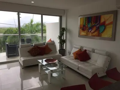 a living room with two couches and a table at Morros Suites Apartamentos in Cartagena de Indias