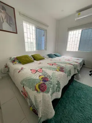 a bedroom with a bed with a colorful bedspread at Cabaña Julianita in Santa Veronica