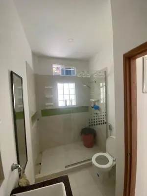 a bathroom with a toilet and a window at Cabaña Julianita in Santa Veronica