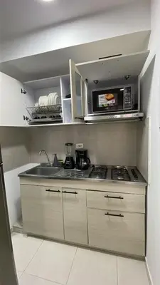 a kitchen with a sink and a microwave at Cozy & Nice Cartagena apartment near to the beach in Cartagena de Indias