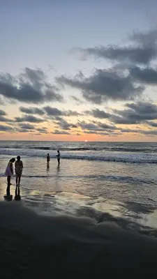 a group of people walking on the beach at PalMar Ecolodge in Moñitos