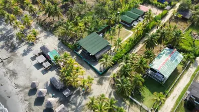 an overhead view of a resort with palm trees at PalMar Ecolodge in Moñitos
