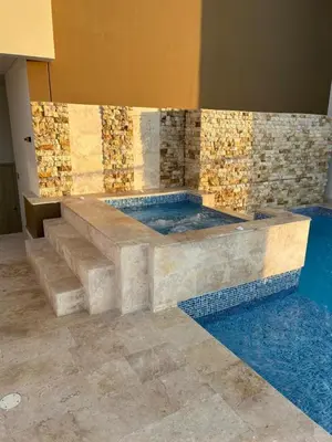 a jacuzzi tub in a room with a tile wall at Apartamento Magno Loft Bocagrande in Cartagena de Indias