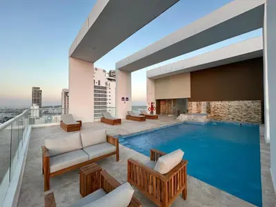 a pool on the roof of a building at Apartamento Magno Loft Bocagrande in Cartagena de Indias