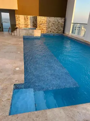a swimming pool with blue water in a building at Apartamento Magno Loft Bocagrande in Cartagena de Indias