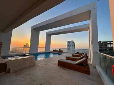 a swimming pool with a view of a building at Apartamento Magno Loft Bocagrande in Cartagena de Indias