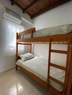 a bedroom with two bunk beds and a window at Casa Española del Mar in Cartagena de Indias