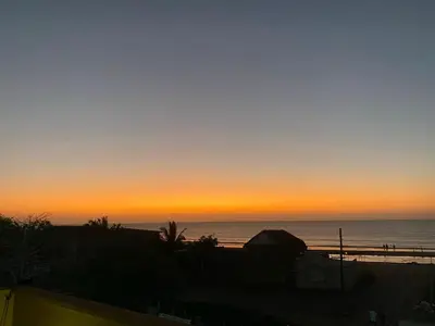 a sunset on the beach with the ocean in the background at Casa Española del Mar in Cartagena de Indias