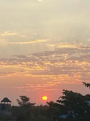 a sunset with the sun in the sky at Casa Española del Mar in Cartagena de Indias