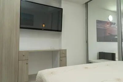 a bedroom with a bed and a tv on a wall at Loft apartment with sea view in Cartagena de Indias