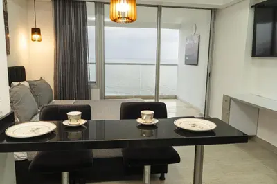 a dining room with a table and chairs with a view at Loft apartment with sea view in Cartagena de Indias