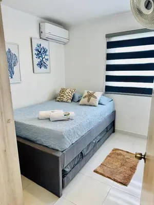 a bedroom with a bed with blue and white walls at TorrePRIMI1905 in Cartagena de Indias