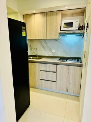 a small kitchen with a sink and a microwave at TorrePRIMI1905 in Cartagena de Indias
