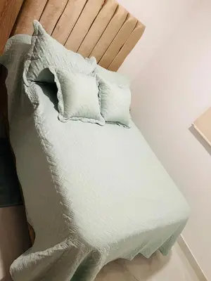 a bed with white sheets and pillows on it at Apartamento Marbella Piso 28 - Playa in Cartagena de Indias