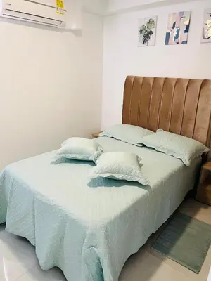 a bed with two pillows on it in a bedroom at Apartamento Marbella Piso 28 - Playa in Cartagena de Indias