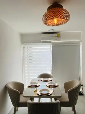 a dining room table with chairs and aendant light at Apartamento Marbella Piso 28 - Playa in Cartagena de Indias