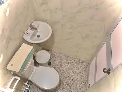 a bathroom with a white toilet and a sink at Hostal La FLora in Cartagena de Indias