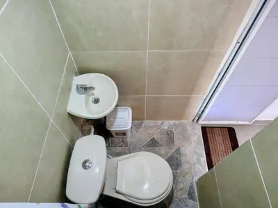 a bathroom with a toilet and a sink at Hostal La FLora in Cartagena de Indias