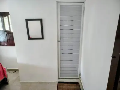a white door in a room with a mirror at Hostal La FLora in Cartagena de Indias