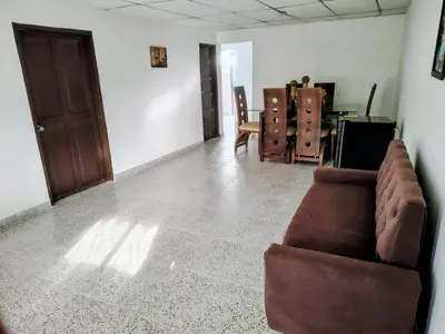 a living room with a couch and a table at Hostal La FLora in Cartagena de Indias