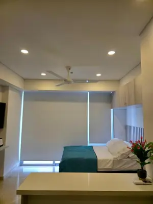 a bedroom with a bed and a ceiling fan at Cartagena Beach Exclusive apto in Cartagena de Indias