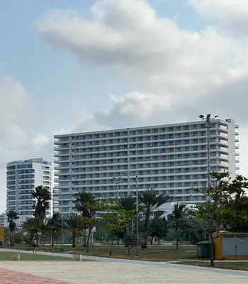 a large white building with trees in front of it at Cartagena Beach Exclusive apto in Cartagena de Indias