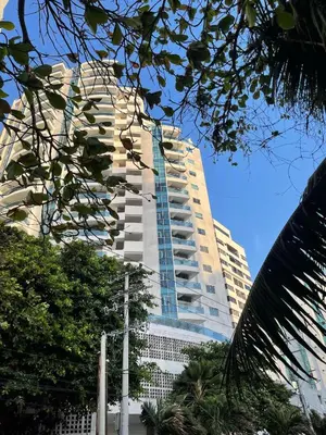 a tall white building with a lot of windows at Apartamento a 1 minuto de la playa in Cartagena de Indias