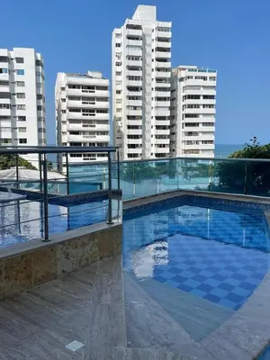 a swimming pool with tall buildings in the background at Apartamento a 1 minuto de la playa in Cartagena de Indias
