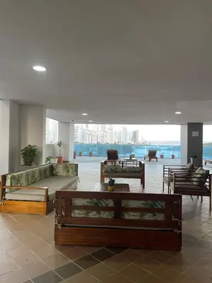 a lobby with couches and tables in a building at Apartamento a 1 minuto de la playa in Cartagena de Indias