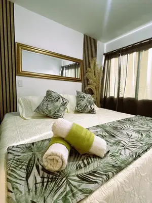 a bedroom with a bed with a towel on it at Serenity Flat in Puerto Tierrabaja