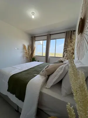 a bedroom with a large bed with a window at cartagena apto castelo serena del mar in Puerto Tierrabaja