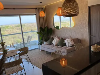 a living room with a couch and a table at cartagena apto castelo serena del mar in Puerto Tierrabaja