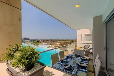 a view from the balcony of a house with a dining table at Mágico Oasis en Baia Kristal Vista a la Laguna 2BR in Los Arrayanes