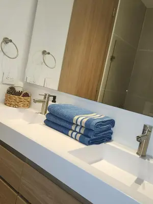 a bathroom sink with a blue towel on it at Con jacuzzi privado, laguna y Paddle board in Cartagena de Indias