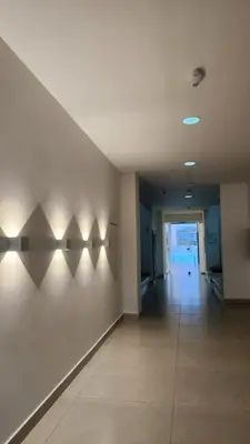 an empty hallway with lights on the wall at Con jacuzzi privado, laguna y Paddle board in Cartagena de Indias