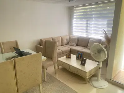 a living room with a couch and a table at Apartamento en Villa Carolina in Barranquilla