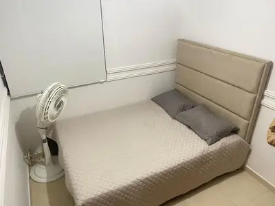 a small bed in a room with a fan at Apartamento en Villa Carolina in Barranquilla