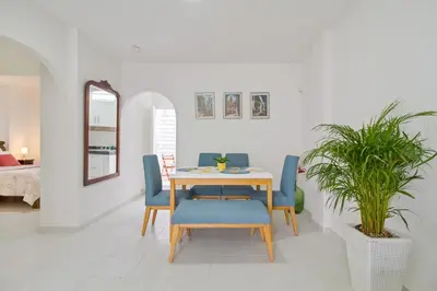a dining room with a table and blue chairs at Apartamento comodo con excelente ubicacion in Cartagena de Indias